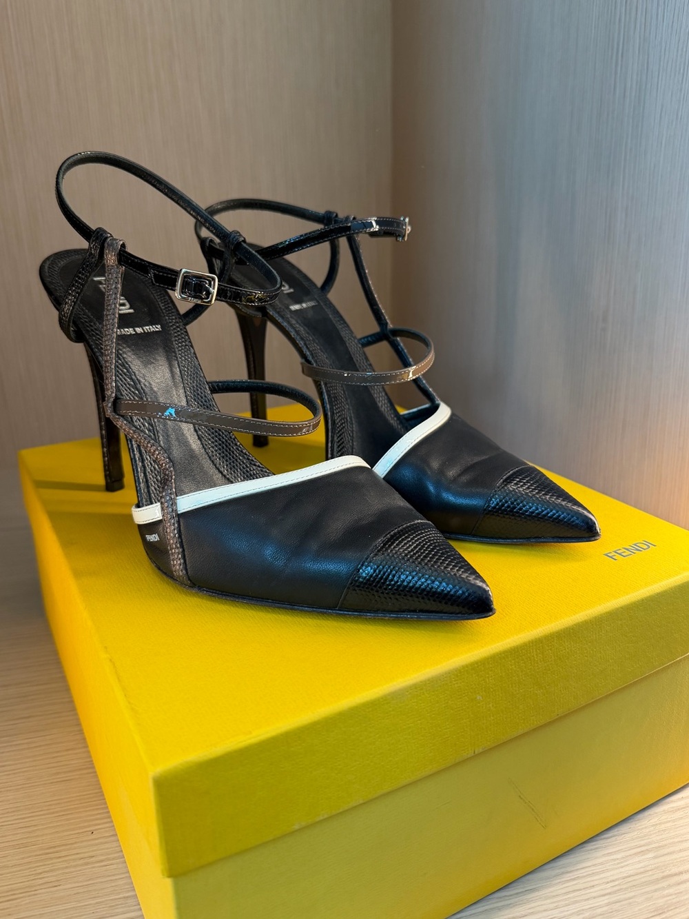 Fendi Black Leather Pointed-Toe Strappy Pumps with White Trim.